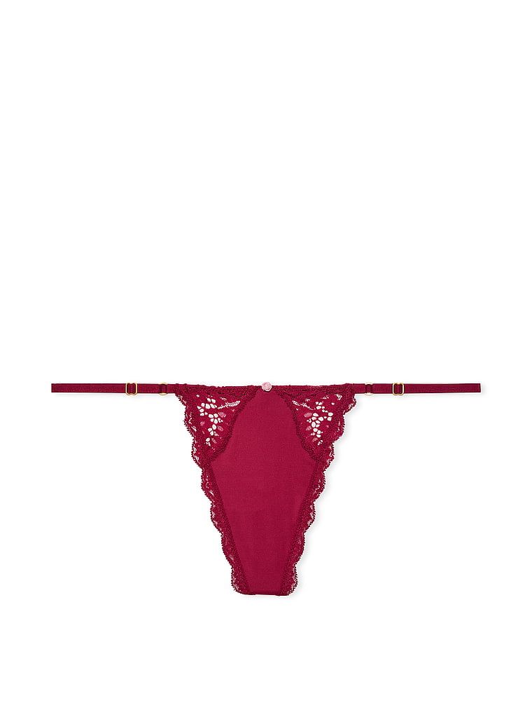 Krajková tanga s nastavitelnými V-String popruhy s lemováním na šněrování. Produkt je červený a pochází z kolekce Dream Angels.