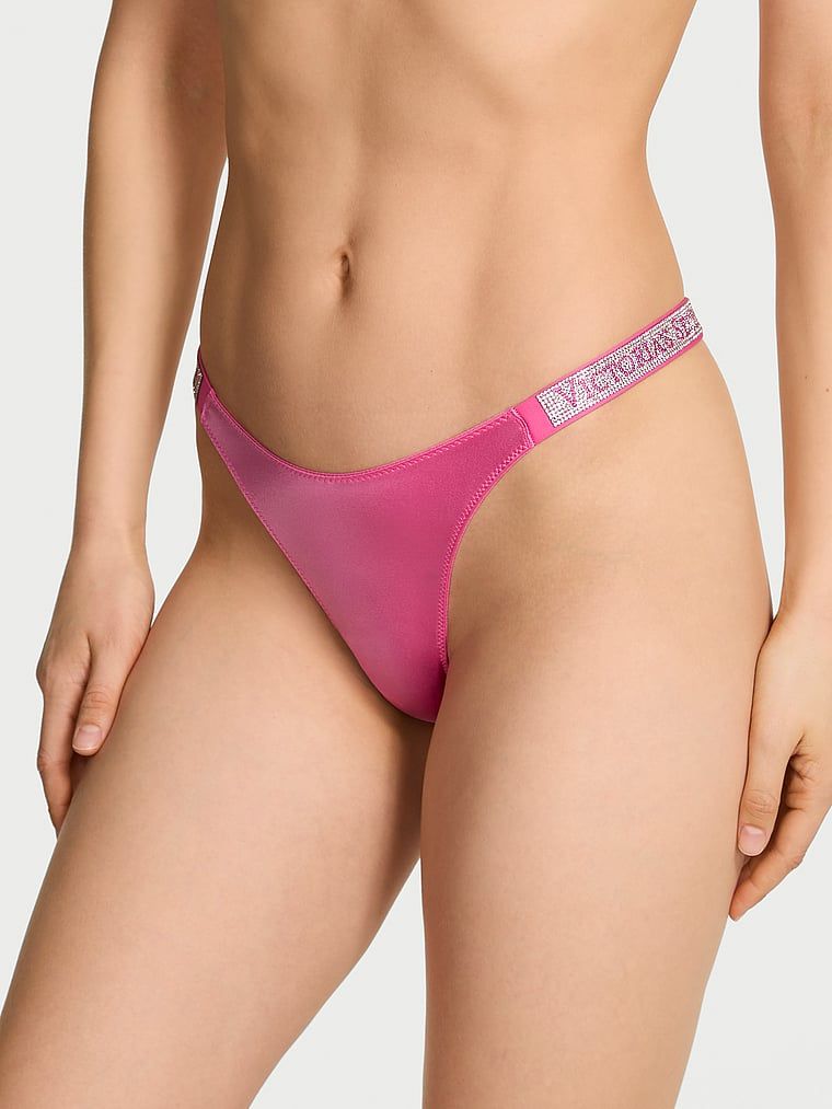 Tanga s lesklými ramínky Shine Strap. Produkt je růžové barvy a pochází z kolekce Very Sexy.