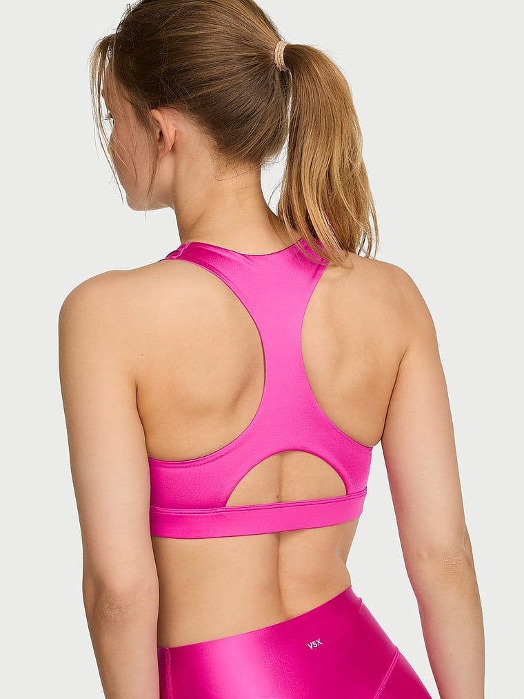 Sportovní podprsenka vyrobená z lesklého materiálu VSX GlossyTech. Produkt je růžové barvy a pochází z kolekce VSX.