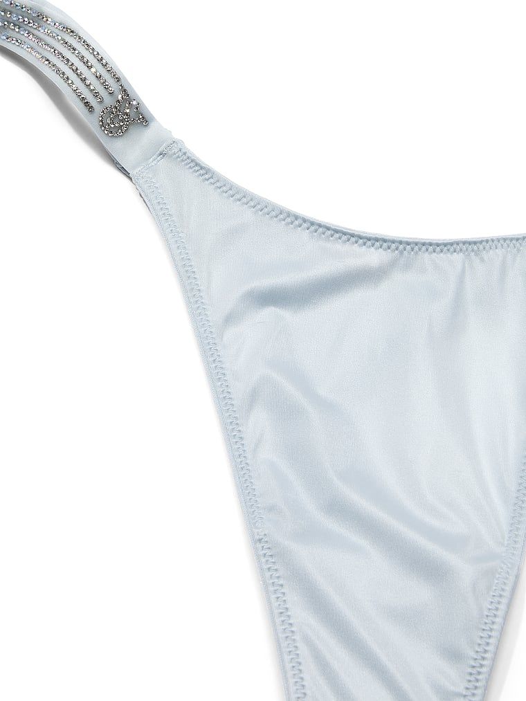 Tanga s lesklými pruhy Shine. Produkt je modré barvy a pochází z kolekce Very Sexy.