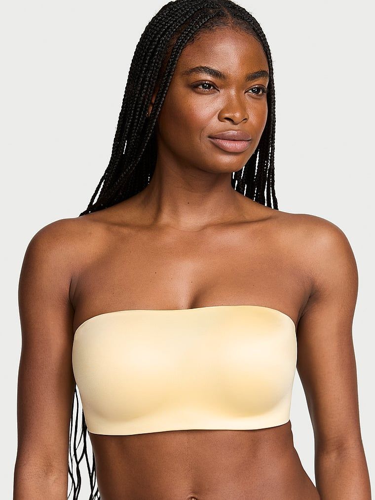 Bandeau podprsenka bez ramínek a s kosticí s klikami. Produkt je žluté barvy a pochází z kolekce Invisible by Victoria's Secret.