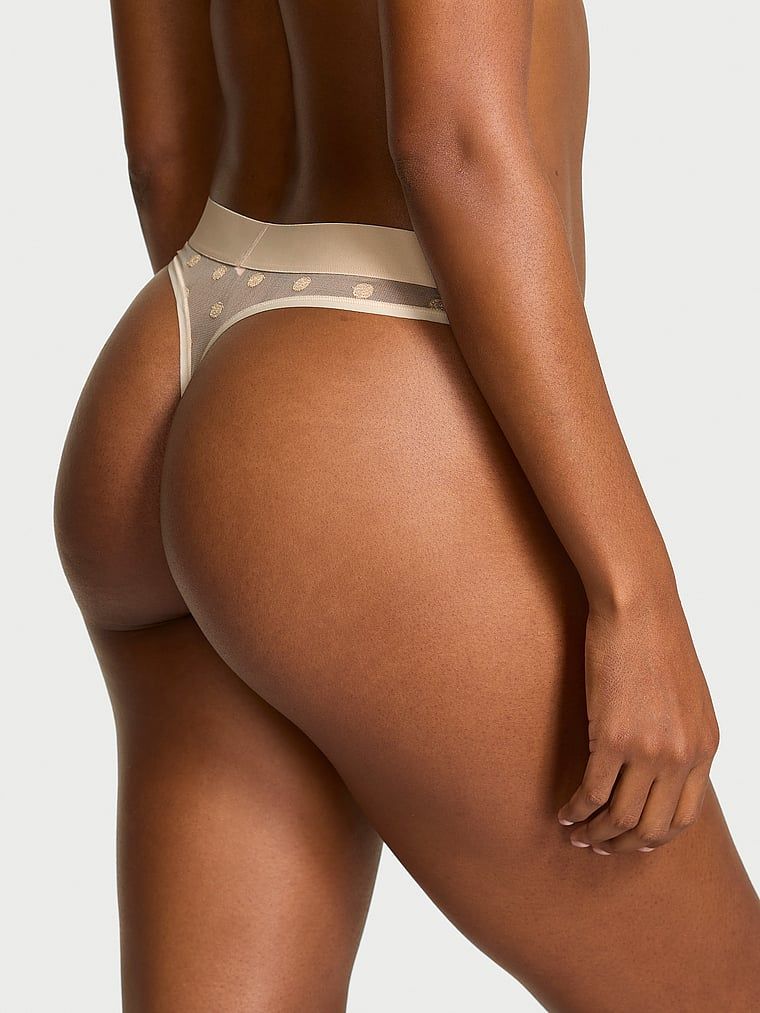 Průhledná tanga ze síťoviny Heritage Shimmer. Výrobek má zlatou barvu a pochází z kolekce Cotton.