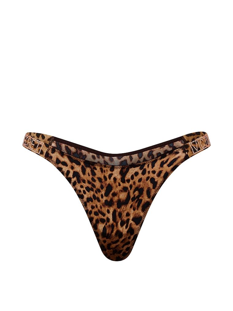 Tanga s lesklými ramínky Shine Strap. Produkt má vzorovanou barvu a pochází z kolekce Very Sexy.
