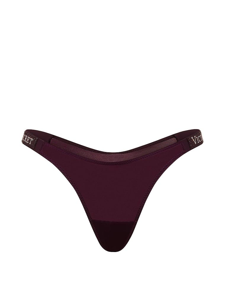 Tanga s lesklými ramínky Shine Strap. Produkt je fialové barvy a pochází z kolekce Very Sexy.
