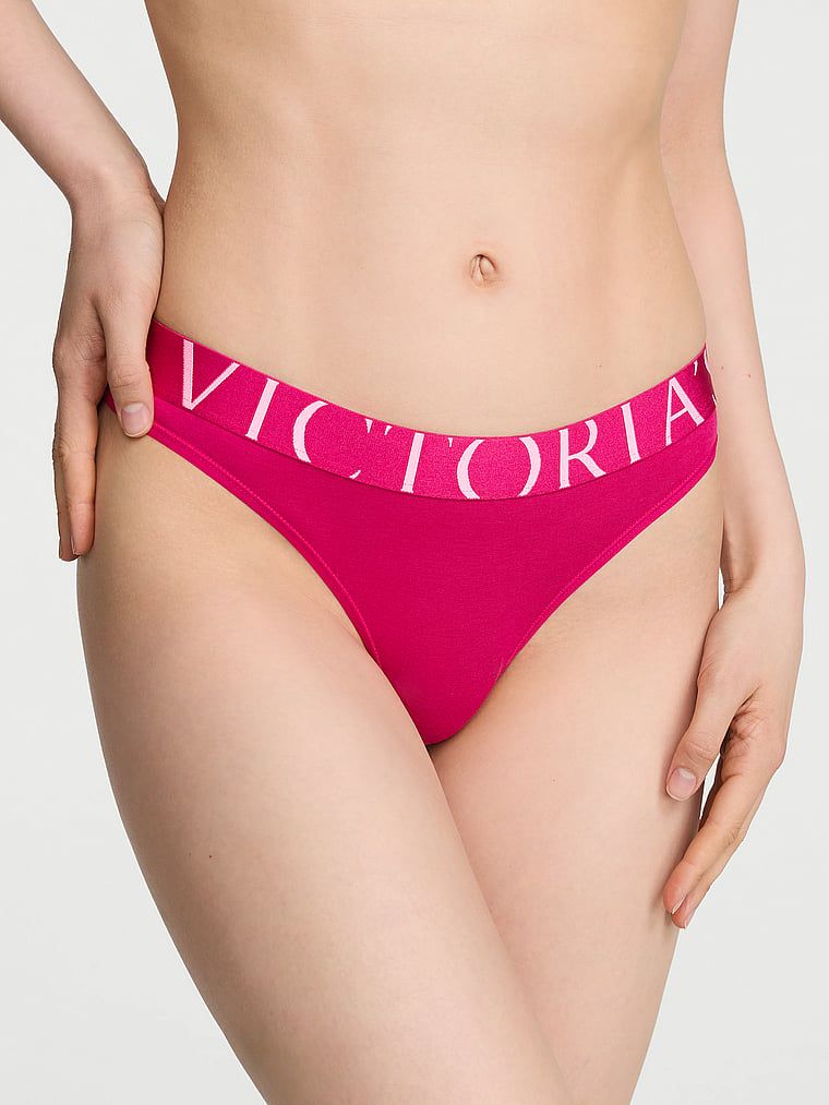 Logo s výbuchem bavlněných tang. Produkt je růžové barvy a pochází z kolekce Cotton.