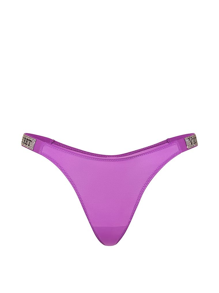 Tanga s lesklými ramínky Shine Strap. Produkt je fialové barvy a pochází z kolekce Very Sexy.