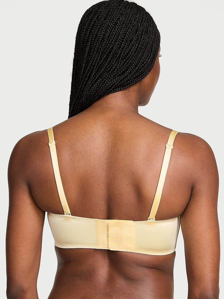 Bandeau podprsenka bez ramínek a s kosticí s klikami. Produkt je žluté barvy a pochází z kolekce Invisible by Victoria's Secret.
