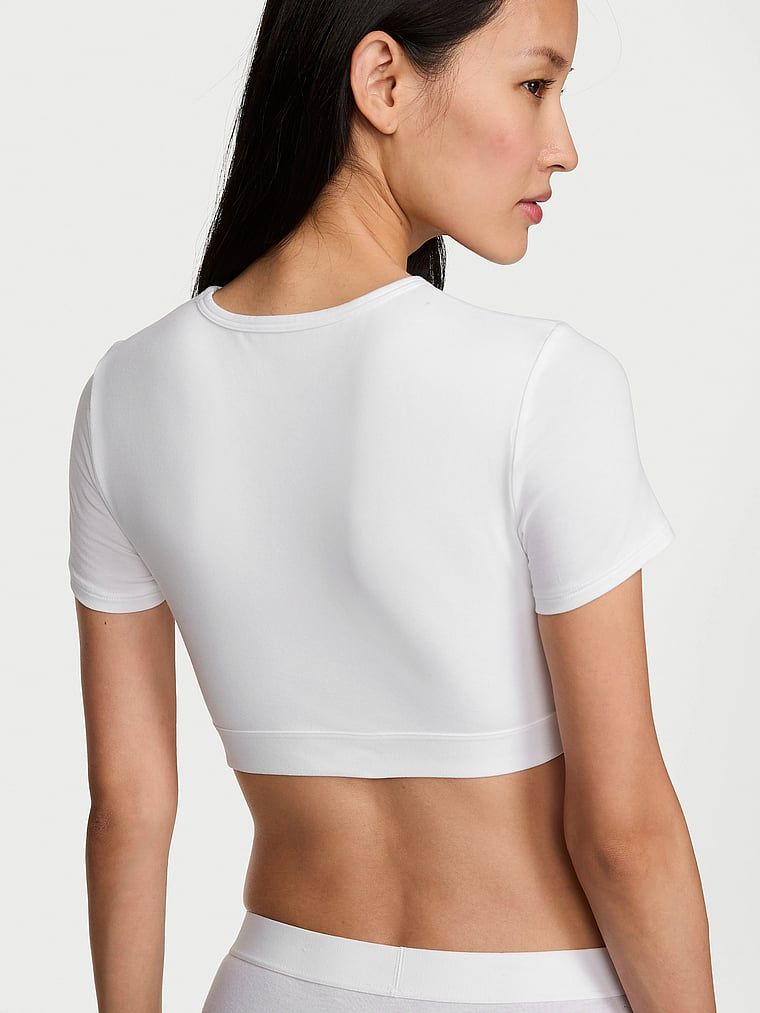 Crop top bavlněná braletka s krátkým rukávem Shine Patch. Produkt je bílé barvy a pochází z kolekce triček.