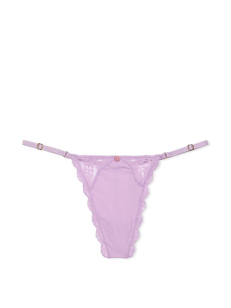 Krajková tanga s nastavitelnými V-String popruhy s lemováním na šněrování. Produkt je fialový a pochází z kolekce Dream Angels.