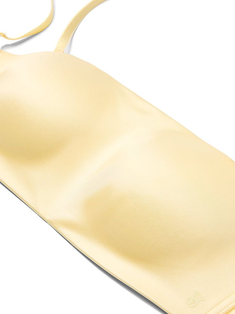 Bandeau podprsenka bez ramínek a s kosticí s klikami. Produkt je žluté barvy a pochází z kolekce Invisible by Victoria's Secret.