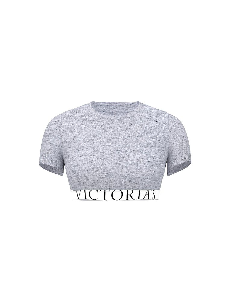 Bavlněný crop top s krátkými rukávy. Produkt je šedé barvy a pochází z kolekce triček.