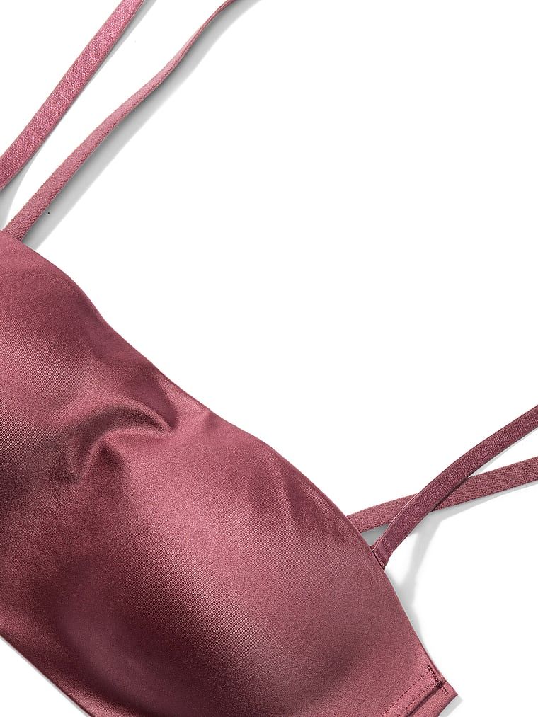 Bandeau podprsenka bez ramínek a s kosticí s klikami. Produkt je růžové barvy a pochází z kolekce Invisible by Victoria's Secret.