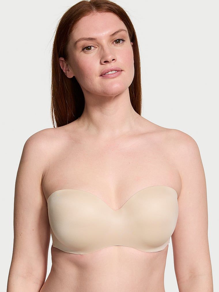 Mírně vyztužená podprsenka bez ramínek. Produkt je béžový a pochází z kolekce Body by Victoria.