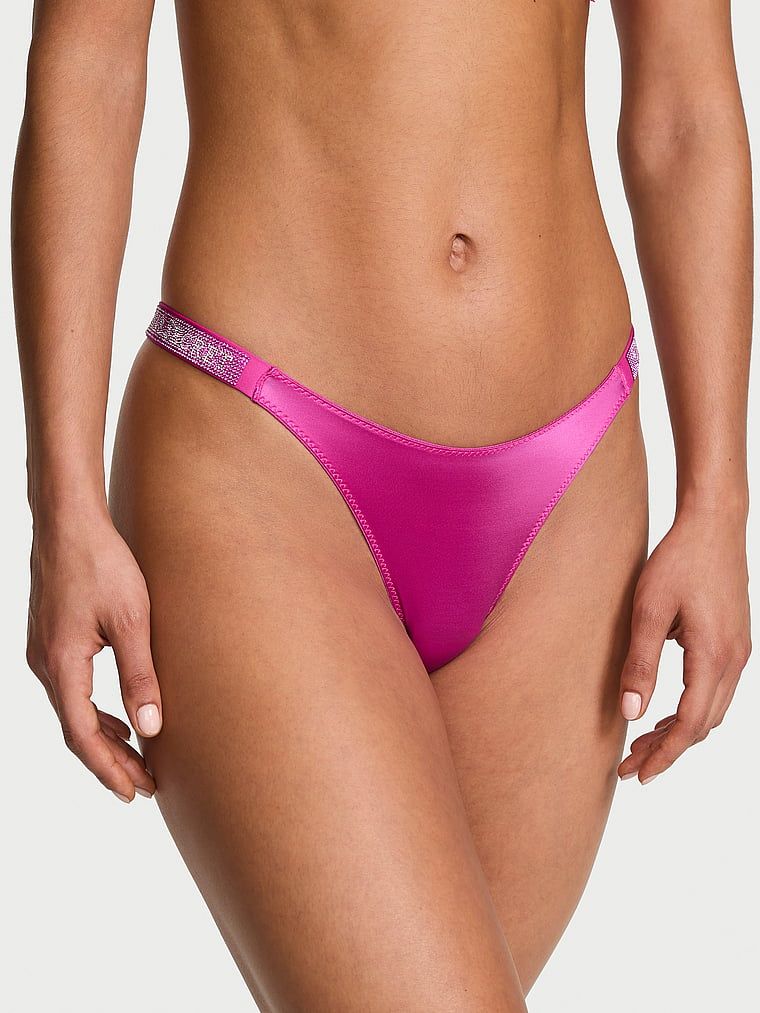 Tanga s lesklými ramínky Shine Strap. Produkt je růžové barvy a pochází z kolekce Very Sexy.