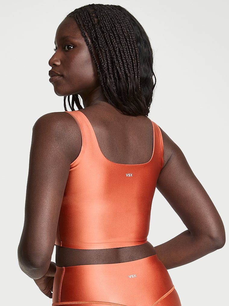 Sportovní top z vysoce lesklého materiálu VSX GlossyTech. Produkt je oranžový a pochází z kolekce VSX.