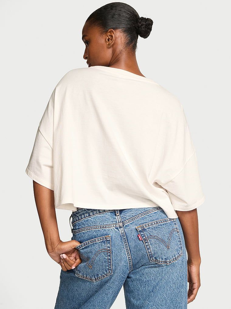 Bavlněné tričko oversize s logem značky. Produkt je bílé barvy a pochází z kolekce Angel Essentials.