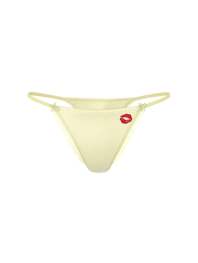 Satenová tanga s vystřiženými nohavičkami Tease Kiss. Produkt je žluté barvy a pochází z kolekce Victoria's Secret.