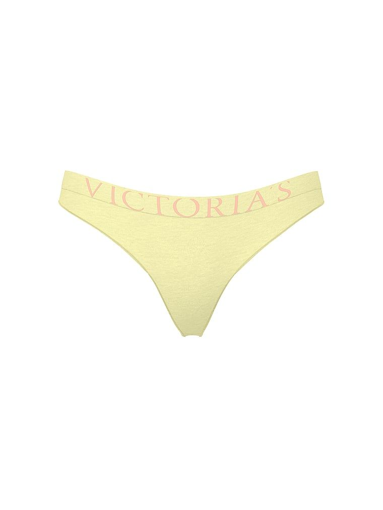 Logo s výbuchem bavlněných tang. Produkt je žluté barvy a pochází z kolekce Cotton.